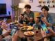 Exciting Slot7000 gaming scene with players enjoying mobile games in a vibrant living room setting.